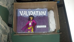 box of copies of Validation Comicon Special