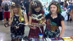 three girls read copies of Validation.