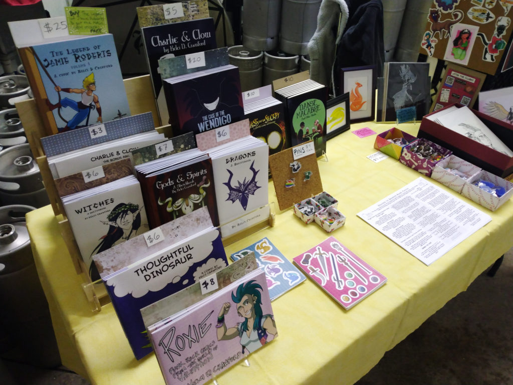 a close-up shot of my artist alley table, focusing on my books.