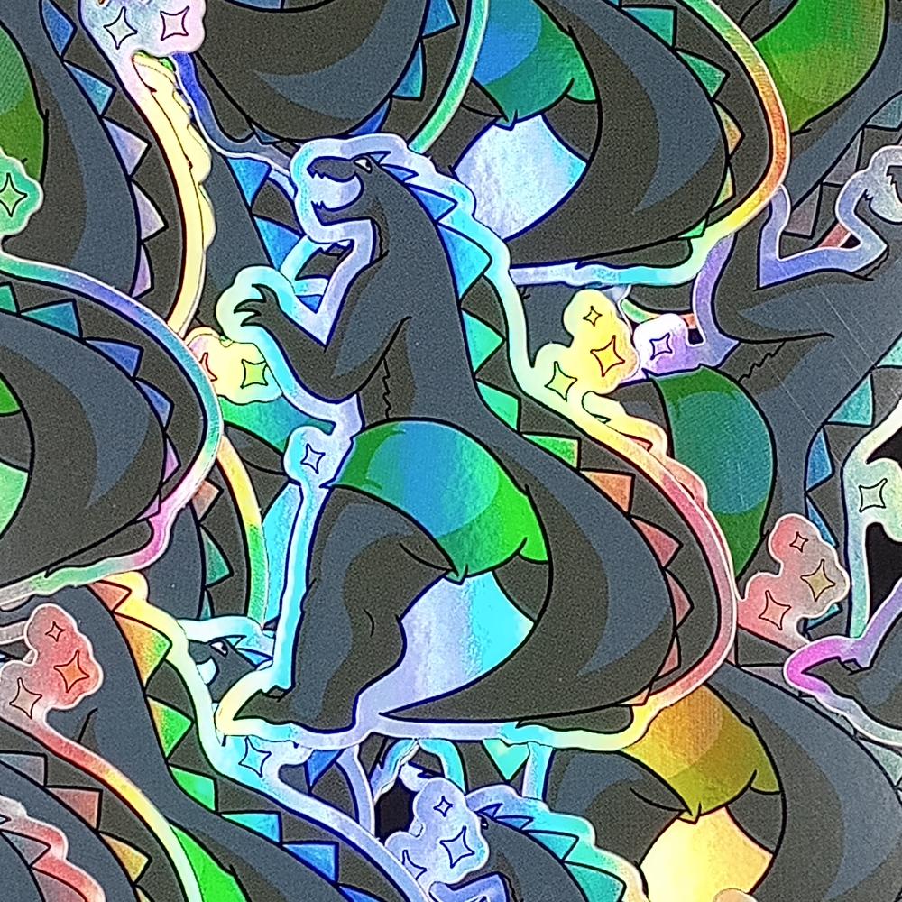 holographic sticker of godzilla in booty shorts with a big, goofy smile